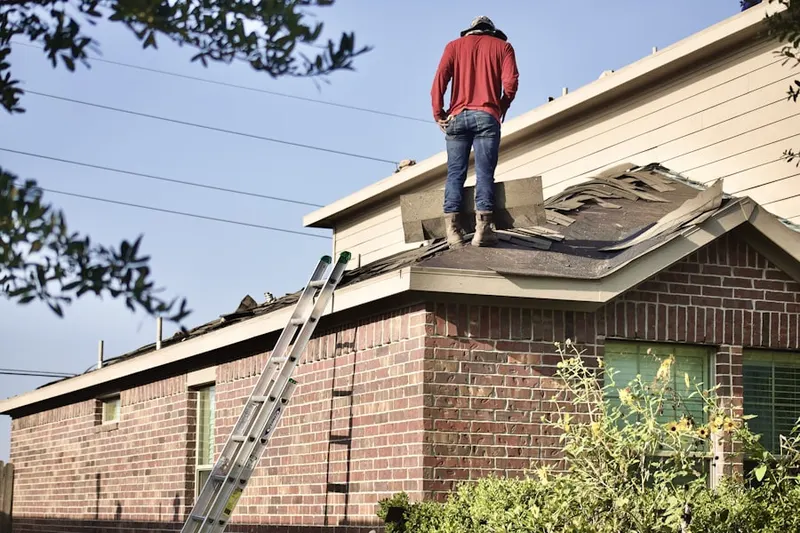 Professional roofer working on a residential roof in Woodland